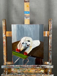 a painting of a white dog on an easel