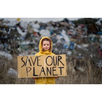 a girl holding a sign that says save our planet