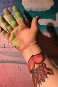 a person's hand with a jellyfish tattoo on it