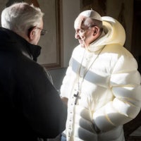 pope francis talks to a man in a white coat