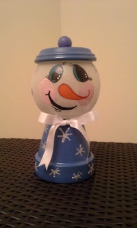 a blue and white snowman sitting on top of a table