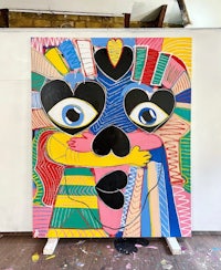 a large painting with a colorful face on it