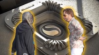 two people standing in front of a large speaker