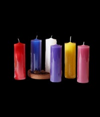 a group of colorful candles on a black background