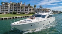 a white motor yacht is traveling down the water