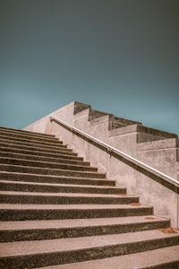 a skateboarder is going up a set of stairs