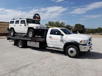 a hummer h2 on a flatbed tow truck
