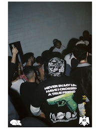 a group of people standing in a room with a t - shirt
