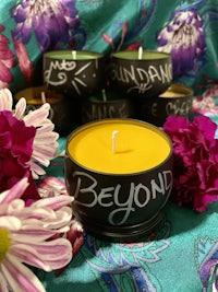 a candle with the word beyond written on it
