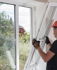 a man is installing a window in a house
