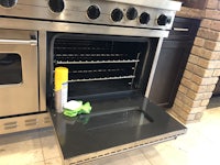 a stainless steel oven with a cleaning cloth in it