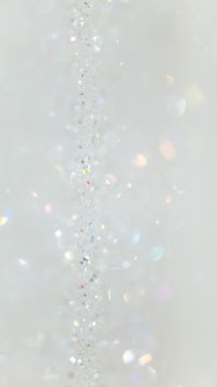 a close up of a white background with a lot of sparkles