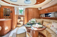 the interior of a boat with a table and chairs