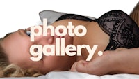 a woman in lingerie laying on a bed with the words photo gallery