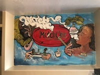 a mural of a woman smoking a cigarette on a wall
