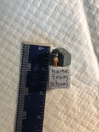 a small piece of paper next to a ruler
