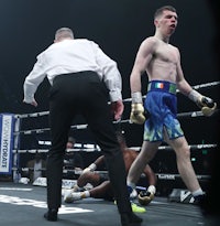 a boxer in a boxing ring with a referee