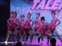 a group of young dancers performing on stage