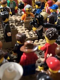 a group of lego people gathered around a table