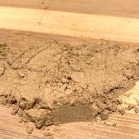 a close up of a brown powder on a wooden surface
