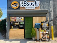 the front of a sushi shop with a sign on it