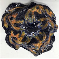 a ceramic piece with a blue and orange design