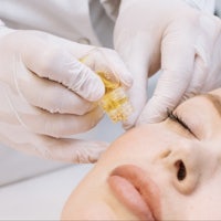 a woman getting a facial treatment at a beauty salon