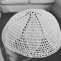 a black and white photo of a crocheted hat