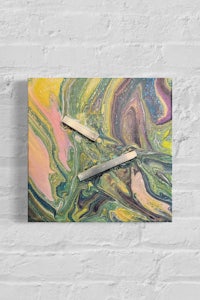 a painting of a yellow, green, and pink painting on a brick wall