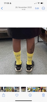 a person's feet are shown in a pair of yellow socks