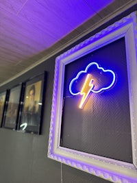 a neon sign with a lightning bolt on it