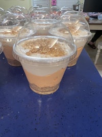 a group of desserts in plastic cups on a table