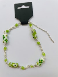 a green glass bead bracelet on a silver chain