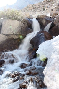 a small stream flowing through rocks and boulders