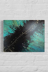 a black and green abstract painting on a brick wall