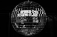 a black and white photo of a disco ball