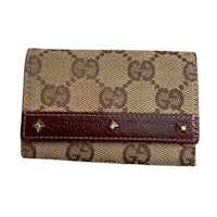 a gucci wallet with a brown leather strap