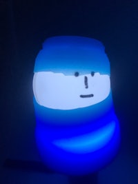 a blue light up mug with a blue face on it