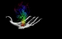 a hand holding a rainbow colored flame on a black background