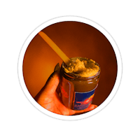 a person holding a jar of peanut butter