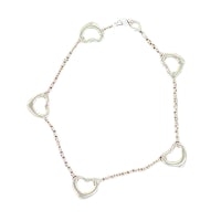 a bracelet with four hearts on a white background