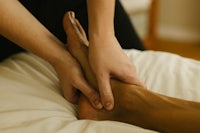 a person getting a foot massage on a bed
