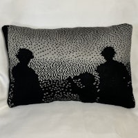 a black and white pillow with silhouettes of two people