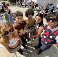 a group of people posing for a picture at a flea market