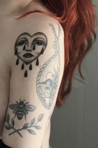 a woman with red hair and tattoos on her arm