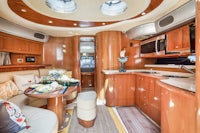 the interior of a motor yacht with a kitchen and dining area