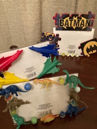 a group of dinosaurs and a batman on a table