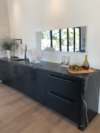 a kitchen with black cabinets and a black island