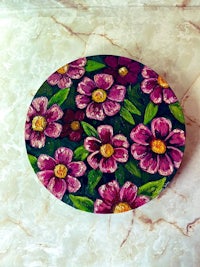 a plate with purple flowers on a marble surface