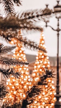 a photo of a christmas tree in front of a lamp post